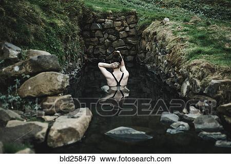 Stock Photo - Caucasian woman swimming in pond. Fotosearch