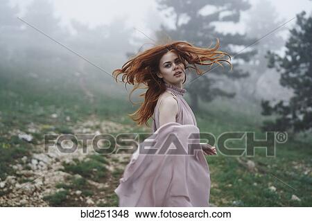 Caucasian woman tossing hair in field View Large Photo Image Stock Photo - Caucasian woman tossing hair in field. Fotosearch