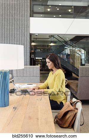Caucasian woman using laptop at table View Large Photo Image Stock Image - Caucasian woman using laptop at table. Fotosearch