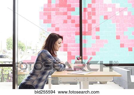 Picture - Caucasian woman using laptop. Fotosearch
