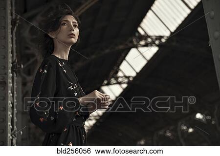 Stock Photograph - Caucasian woman waiting at train station. Fotosearch