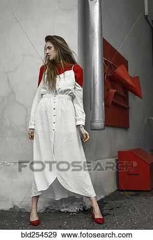Caucasian woman wearing dress leaning on corner View Large Photo Image Stock Photo - Caucasian woman wearing dress leaning on corner. Fotosearch