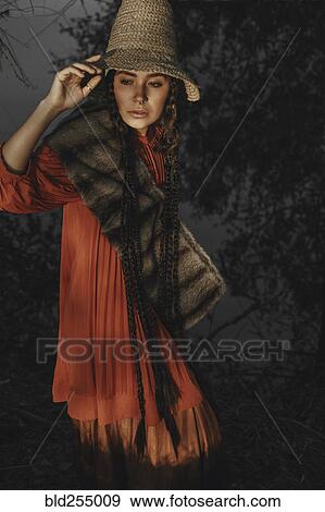 Stock Photo - Caucasian woman wearing traditional clothing at night. Fotosearch