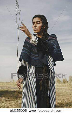 Caucasian woman wearing traditional clothing examining twig View Large Photo Image Stock Photograph - Caucasian woman wearing traditional clothing examining twig. Fotosearch
