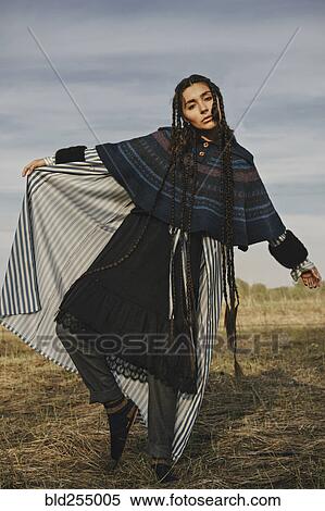 Stock Photography - Caucasian woman wearing traditional clothing dancing in field. Fotosearch