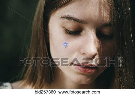 Caucasian woman with flower jewelry on cheek View Large Photo Image Stock Image - Caucasian woman with flower jewelry on cheek. Fotosearch