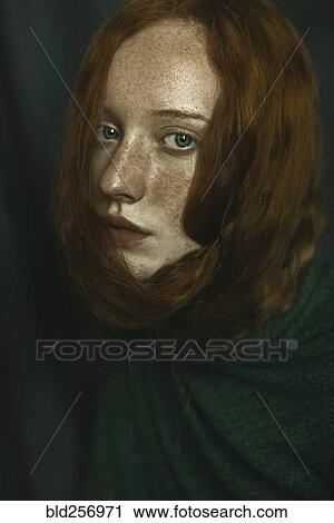 Stock Image - Caucasian woman with hair wrapped around face. Fotosearch