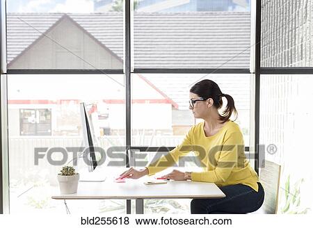 Caucasian woman writing on adhesive notes at desk View Large Photo Image Stock Photo - Caucasian woman writing on adhesive notes at desk. Fotosearch