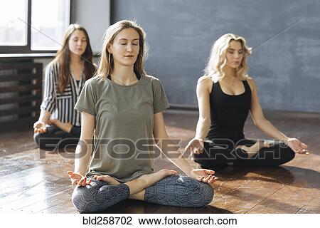 Caucasian women meditating in yoga class View Large Photo Image Stock Image - Caucasian women meditating in yoga class. Fotosearch
