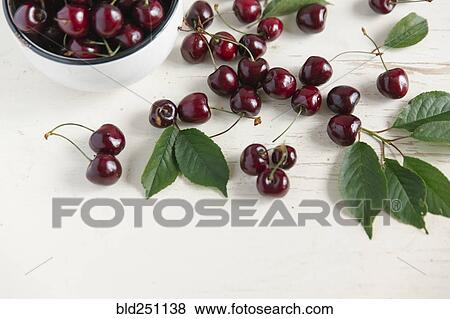 Cherries and bowl on white wooden table View Large Photo Image Stock Photo - Cherries and bowl on white wooden table. Fotosearch