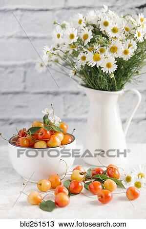 Cherries on white wooden table near vase of flowers View Large Photo Image Stock Image - Cherries on white wooden table near vase of flowers. Fotosearch