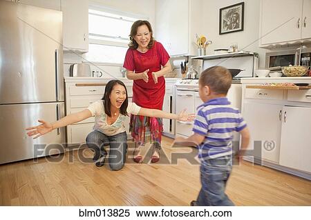 Chinese family bonding in kitchen View Large Photo Image Stock Photography - Chinese family bonding in kitchen. Fotosearch