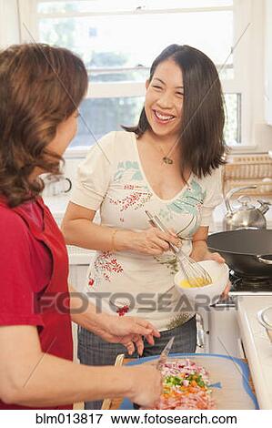 Stock Photo - Chinese mother and daughter cooking together. Fotosearch