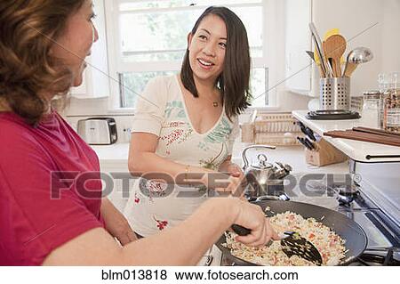 Stock Photo - Chinese mother and daughter cooking together. Fotosearch
