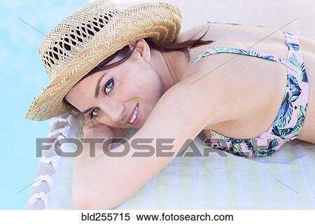 Close up of Caucasian woman laying near swimming pool View Large Photo Image Stock Photography - Close up of Caucasian woman laying near swimming pool. Fotosearch