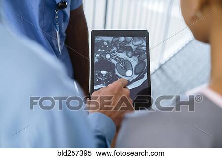 Close up of doctor and nurses viewing image on digital tablet View Large Photo Image Stock Photography - Close up of doctor and nurses viewing image on digital tablet. Fotosearch