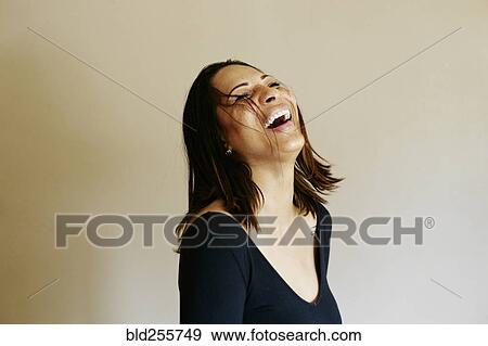Stock Photo - Close up of laughing mixed race woman. Fotosearch