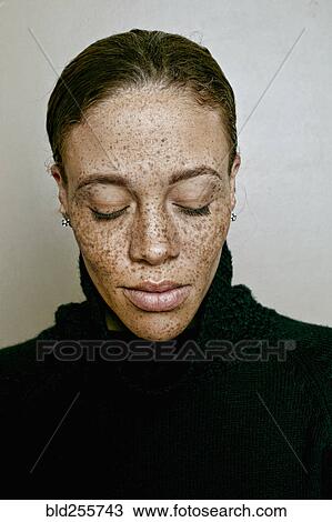 Stock Image - Close up of mixed race woman with eyes closed. Fotosearch