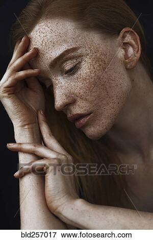 Close up of pensive Caucasian woman with freckles View Large Photo Image Stock Photo - Close up of pensive Caucasian woman with freckles. Fotosearch