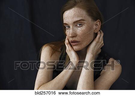 Stock Photograph - Close up of serious Caucasian woman with freckles. Fotosearch