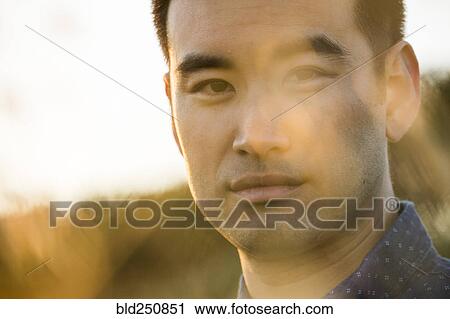 Stock Image - Close up of serious Chinese man. Fotosearch