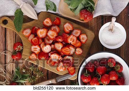Close up of sliced strawberries on cutting board View Large Photo Image Stock Image - Close up of sliced strawberries on cutting board. Fotosearch