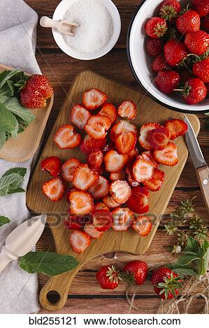 Close up of sliced strawberries on cutting board View Large Photo Image Stock Image - Close up of sliced strawberries on cutting board. Fotosearch