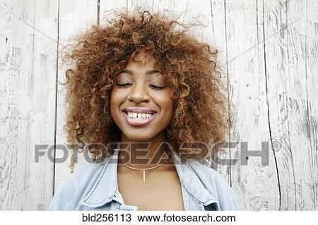 Close up of smiling black woman with eyes closed View Large Photo Image Stock Image - Close up of smiling black woman with eyes closed. Fotosearch
