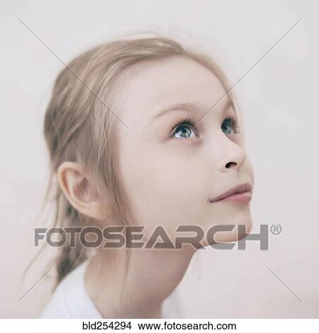 Close up of smiling Caucasian girl looking up View Large Photo Image Picture - Close up of smiling Caucasian girl looking up. Fotosearch