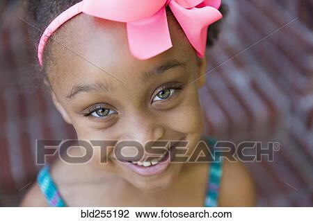 Stock Image - Close up of smiling mixed race girl. Fotosearch