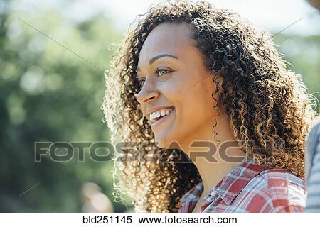 Stock Photography - Close up of smiling mixed race woman. Fotosearch