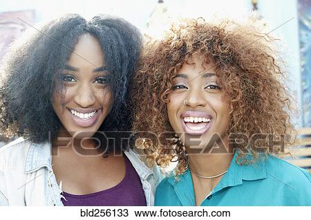 Stock Image - Close up of smiling women. Fotosearch