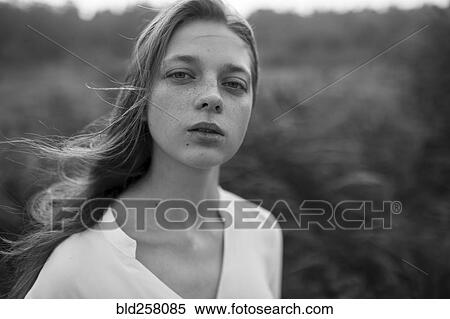 Stock Photography - Close up of wind blowing hair of Caucasian woman. Fotosearch