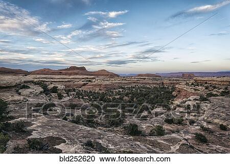 Stock Image - "Clouds in blue sky over desert, Moab, Utah, United States". Fotosearch