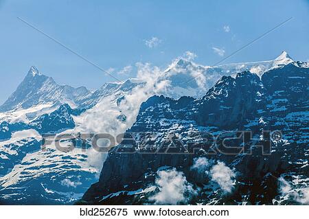 Clouds on snowy mountains View Large Photo Image Stock Photography - Clouds on snowy mountains. Fotosearch