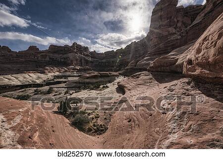 Stock Image - "Clouds over canyon in Moab, Utah, United States". Fotosearch