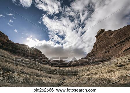 Stock Photograph - "Clouds over canyon in Moab, Utah, United States". Fotosearch