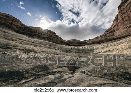 Stock Photography - "Clouds over canyon in Moab, Utah, United States". Fotosearch