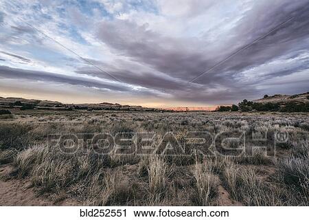 Stock Image - "Clouds over desert in Moab, Utah, United States". Fotosearch