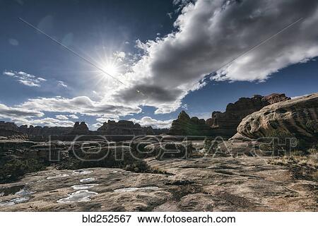 Stock Photo - "Clouds over desert in Moab, Utah, United States". Fotosearch