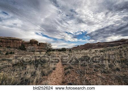 "Clouds over desert path, Moab, Utah, United States" View Large Photo Image Picture - "Clouds over desert path, Moab, Utah, United States". Fotosearch