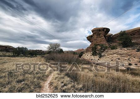 "Clouds over desert path, Moab, Utah, United States" View Large Photo Image Stock Photography - "Clouds over desert path, Moab, Utah, United States". Fotosearch