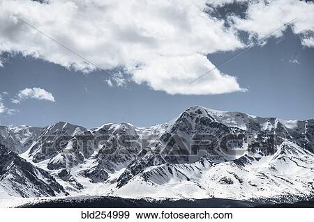 Stock Photo - Clouds over snow covered mountains. Fotosearch