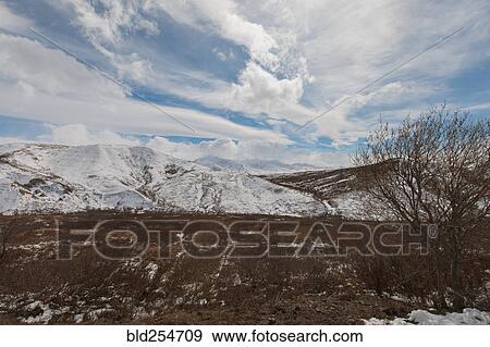 Stock Photo - Clouds over snow on mountain. Fotosearch