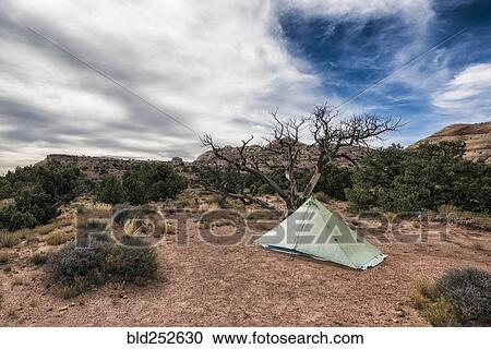 Stock Image - "Clouds over tent in desert, Moab, Utah, United States". Fotosearch