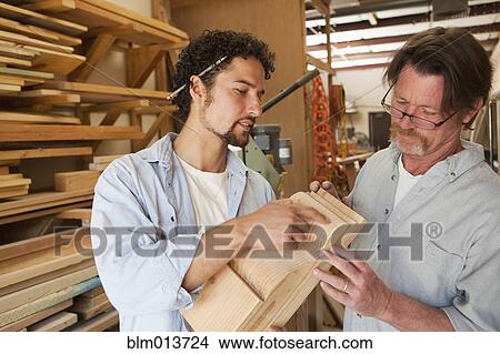 Picture - Co-workers woodworking in workshop. Fotosearch