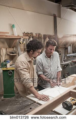 Co-workers woodworking in workshop View Large Photo Image Stock Photograph - Co-workers woodworking in workshop. Fotosearch
