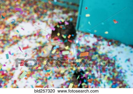 Colorful confetti falling on Caucasian girl View Large Photo Image Stock Image - Colorful confetti falling on Caucasian girl. Fotosearch