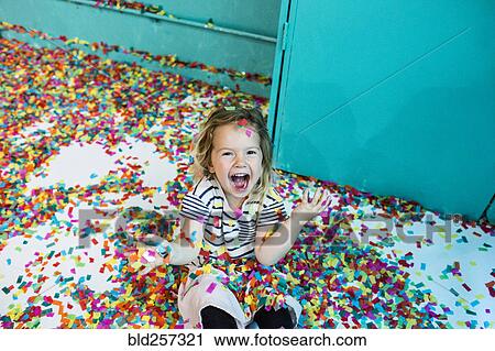 Colorful confetti falling on Caucasian girl View Large Photo Image Stock Image - Colorful confetti falling on Caucasian girl. Fotosearch