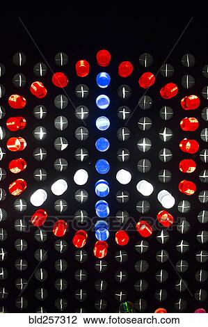 Stock Image - Colorful game pieces on puzzle wall forming peace symbol. Fotosearch